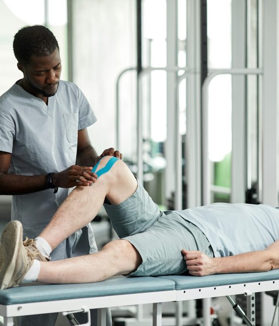 Rehabilitation Therapist Using Tapes Rehabilitation Therapist Using Tapes