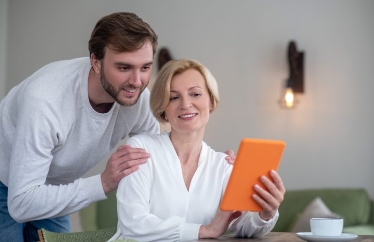 two-people-looking-through-the-photos-on-a-tablet two-people-looking-through-the-photos-on-a-tablet